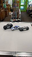 Group shot of three diecast police cars on table