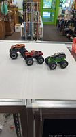 All three monster trucks side by side