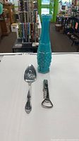 All three items: blue glass vase, pie server, corkscrew