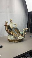 Full view of ceramic fishermen sculpture on table