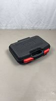 Closed black Skil carry case with red latches