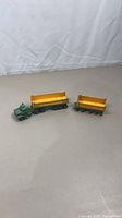 Full view of tractor cab with two dump trailers
