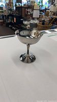 Side view of silver-tone metal goblet on stem