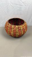 front view of round multicolor woven basket