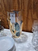 Full view of amber glass vase with blue, grey and white spots