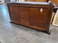 Front view showing drawers, cabinet doors, veneer, decorative base