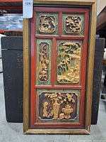 Full view of framed carved wood wall panel