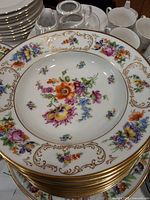 Stacked Bavaria Schumann floral dinner plate and soup bowl set showing pattern and gold trim