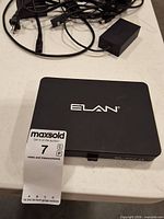 Top view of Elan g1 unit with power adapter and cables visible