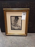 Front view of framed etching with mat and gold frame