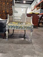 Front view of French Provincial caned armchair