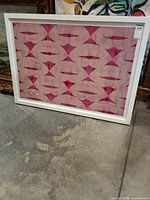 Front view of framed abstract artwork in white frame
