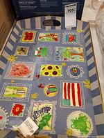Top view of decoupage tray showing artwork, rope handle, hang tag visible