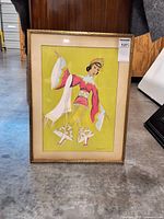 Front view of framed artwork showing dancer illustration