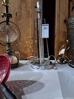 Full view of lucite and chrome table lamp showing acrylic body, chrome base, socket and cord