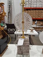 Front view showing marble base, brass stem, glass disk, cord and tag