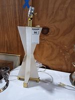 Front view of lamp showing twisted stone body and brass base