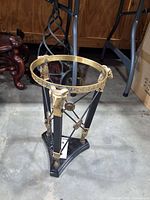 Full view showing entire plant stand base with brass ring, ram heads, and triangular marble base