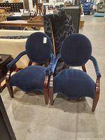 Pair of navy blue velvet armchairs with wooden legs