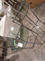 Pair of round glass top chrome end tables showing overall design and condition