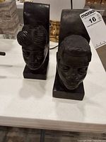 Front view of both carved wood bust bookends