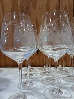 Group of the 15 etched clear glass red wine glasses showing bowl shape, etched pattern and stems