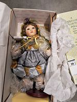 Fairy-jester porcelain doll in box with stand and packaging