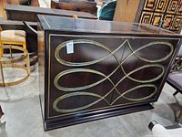 Front view of sideboard showing brass-tone loop trim on doors and overall finish