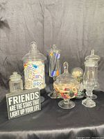 Group view of six apothecary jars, sign and light-up rose showing overall lot
