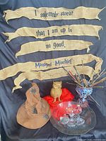 Complete lot showing banners, hat, owl statue, wand holder with wands, glass bowl with ornaments