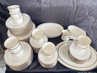 Full set stacked showing place settings and serving pieces