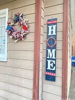 Sign and wreath displayed on exterior wall