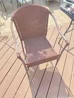 Single brown wicker patio chair on deck