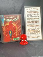 Full lot showing coin bank and both framed pieces