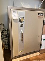 Front view of Aiko steel safe showing dial, key slot, handle