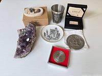 Group image of geode, figurine (boxed), plate, cup, medals, ingot