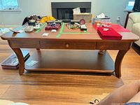front view of coffee table showing drawers, legs and lower shelf