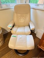 Front view of leather chair and ottoman showing color, design and bases