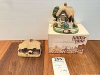 Both cottage figurines, one on box with lot tag