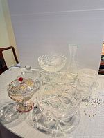 Group shot of all six clear glass and crystal pieces on table