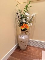 Full view of ceramic vase with faux flowers