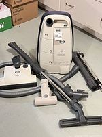 Canister vacuum with hose, heads, wand