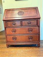 Front view of closed desk showing drawers and carvings