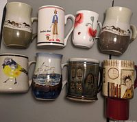 Front view of all eight mugs showing designs