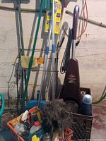 Overall view of Bissell carpet cleaner, wire rack, mops and assorted cleaning supplies