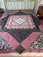 Full view of queen size patchwork quilt on bed showing overall pattern and colors