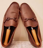 Top view of both loafers showing leather condition and shoe trees