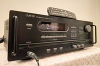 Front view of Carver HTR-880 receiver with remote on top
