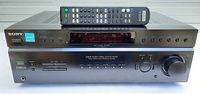 Front view of Sony STR-DE597 receiver with remote placed on top