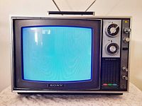 Front view of Sony CRT TV with blue screen and antenna